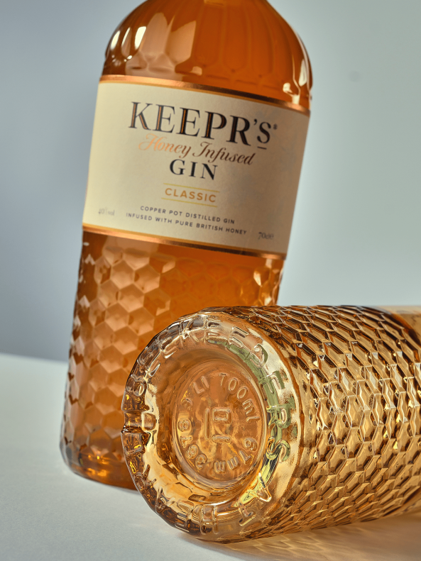 Keepers gin glass bottle made by Verallia, with a bespoke glass mould in the texture of a beehive